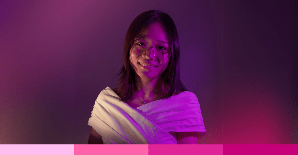 Linda Wang standing in front of a pink background.