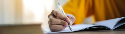 A student writing in a notebook